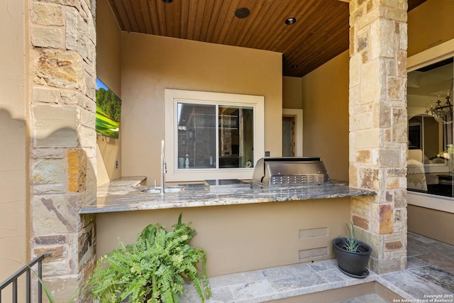 view of patio featuring an outdoor kitchen, a sink, and area for grilling