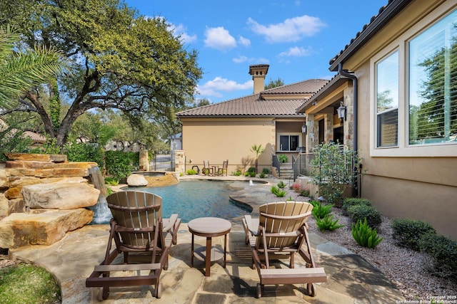 pool featuring fence and a patio