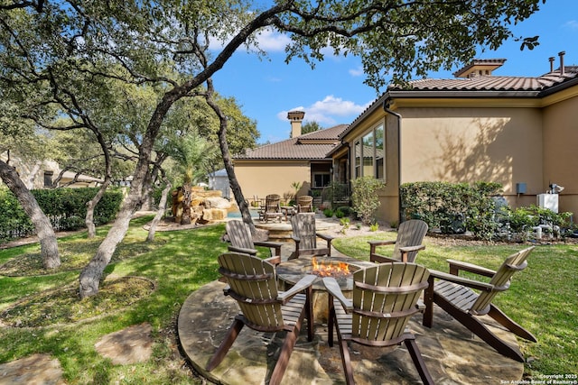 view of patio with a fire pit