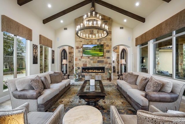 living area with arched walkways, high vaulted ceiling, and a stone fireplace