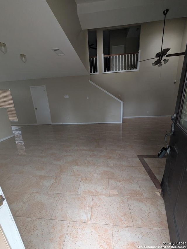 unfurnished living room featuring ceiling fan