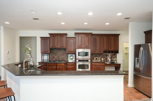 kitchen with a large island, sink, and stainless steel appliances