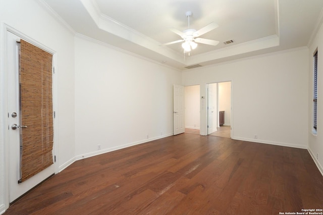 unfurnished bedroom with dark hardwood / wood-style floors, a raised ceiling, ceiling fan, and ornamental molding