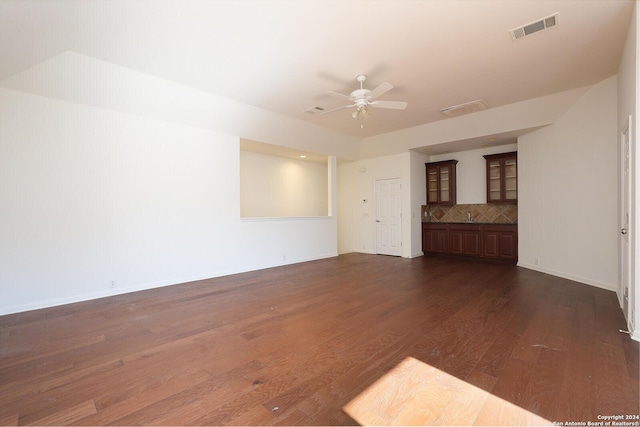 unfurnished living room with ceiling fan and dark hardwood / wood-style flooring