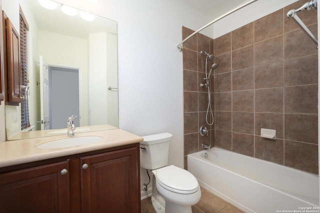 full bathroom featuring vanity, tiled shower / bath combo, and toilet