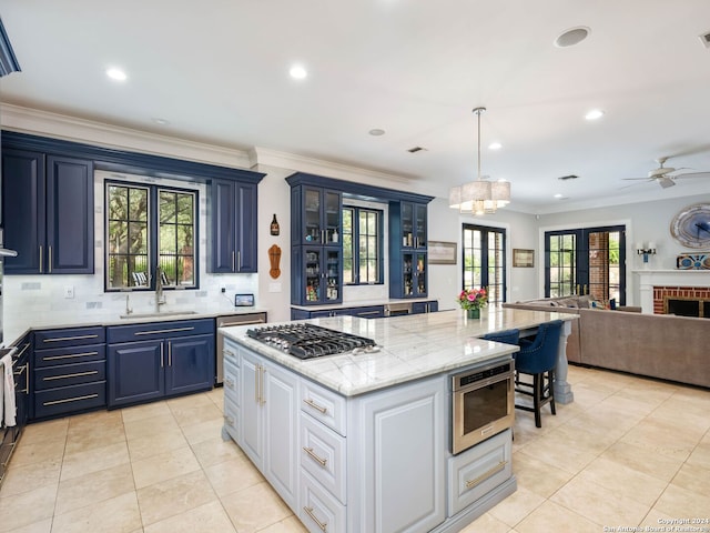 kitchen with french doors, blue cabinets, sink, white cabinetry, and stainless steel gas stovetop