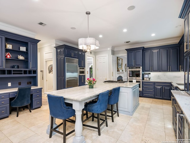 kitchen with appliances with stainless steel finishes, light stone counters, blue cabinets, pendant lighting, and a center island