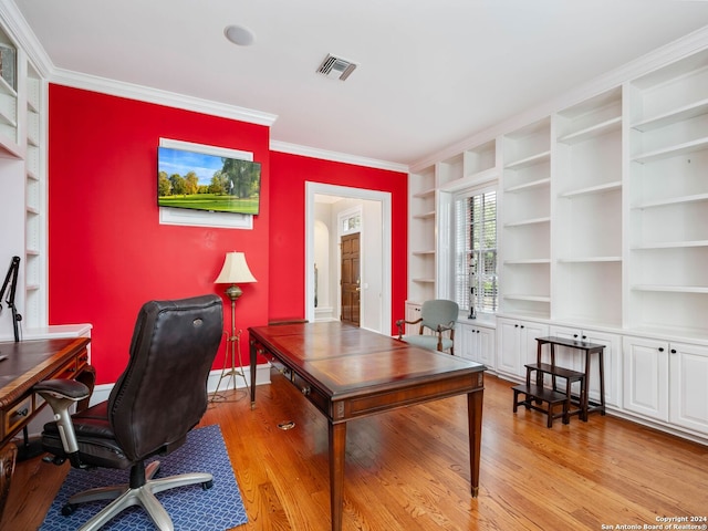 office space with light hardwood / wood-style floors, built in features, and ornamental molding