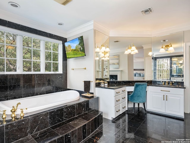 bathroom with vanity, crown molding, and tiled tub