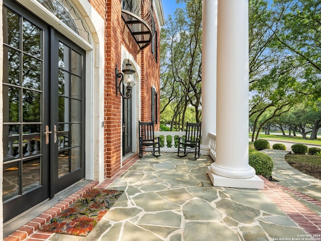 view of patio / terrace with french doors and covered porch