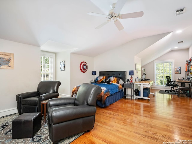 bedroom with multiple windows, hardwood / wood-style flooring, vaulted ceiling, and ceiling fan