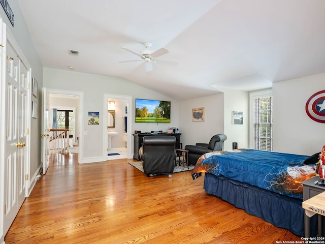 bedroom with multiple windows, light wood-type flooring, ensuite bathroom, and ceiling fan