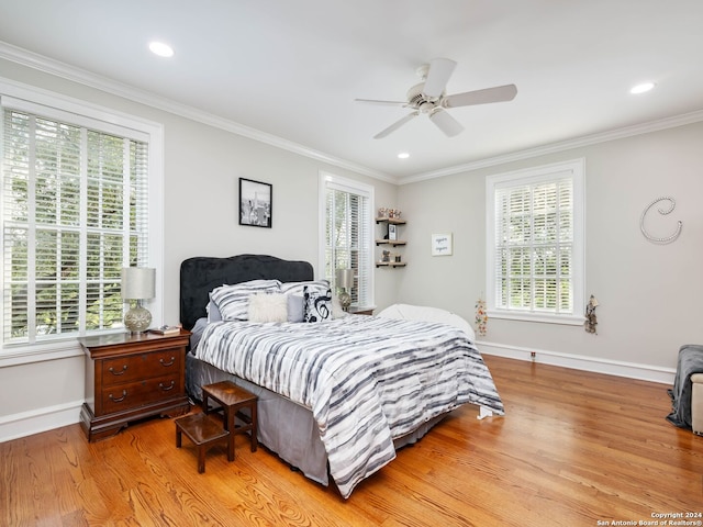 bedroom featuring multiple windows, ceiling fan, and light hardwood / wood-style flooring