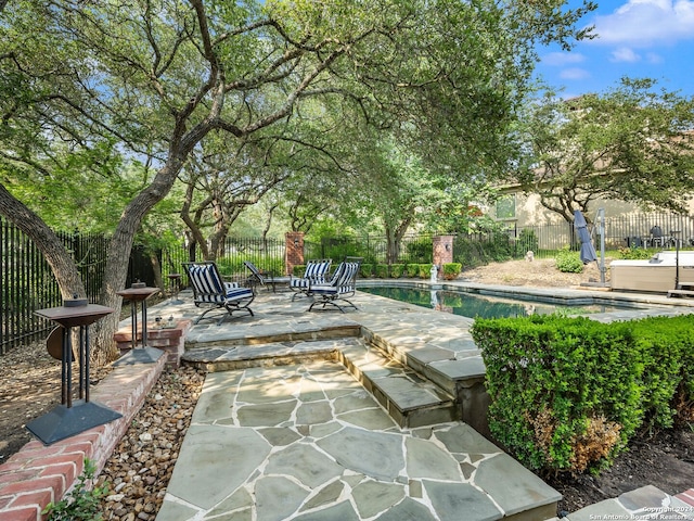 view of patio with a fenced in pool