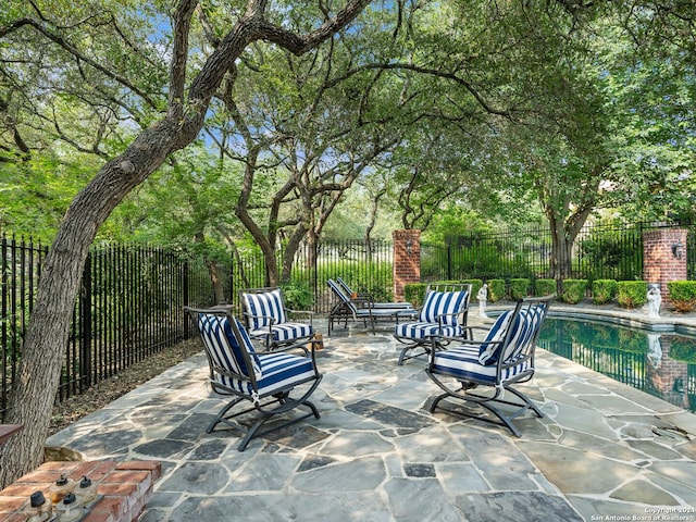 view of patio / terrace with a fenced in pool