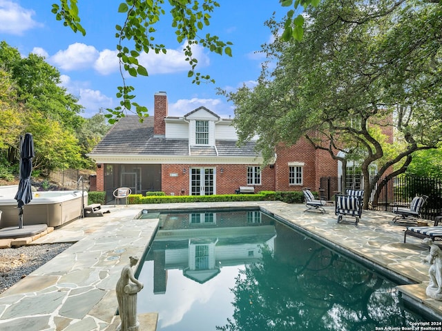 view of pool with a patio and a hot tub