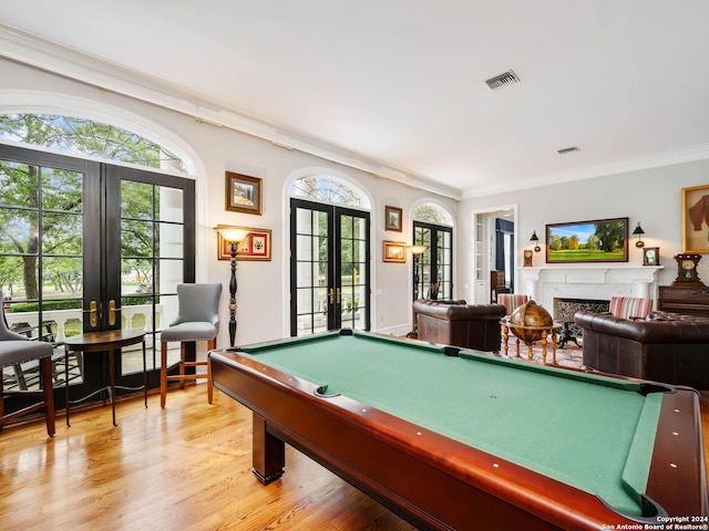 recreation room featuring french doors, light wood-type flooring, crown molding, and billiards