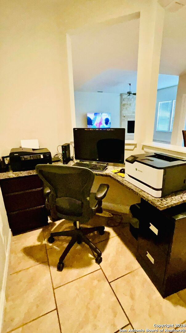 office area featuring tile patterned floors and ceiling fan