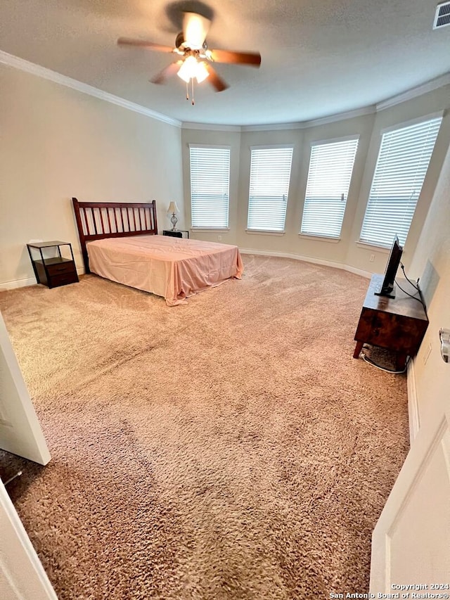 bedroom with ceiling fan, carpet, a textured ceiling, and ornamental molding