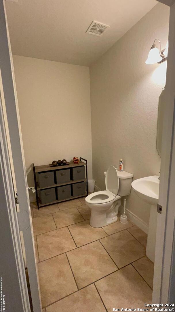 bathroom with tile patterned floors and toilet