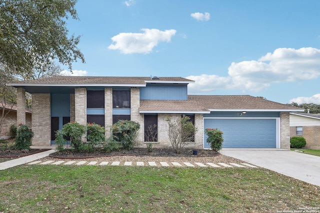 view of front of property featuring a garage and a front lawn