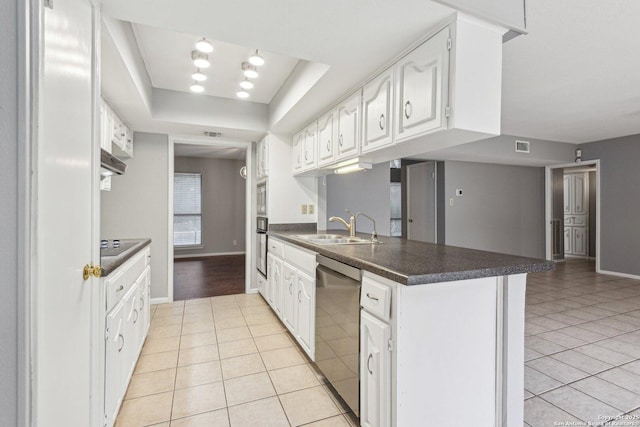 kitchen featuring kitchen peninsula, light tile patterned floors, white cabinets, and stainless steel appliances