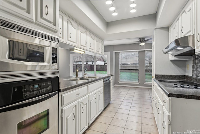 kitchen with sink, white cabinets, stainless steel appliances, and light tile patterned floors