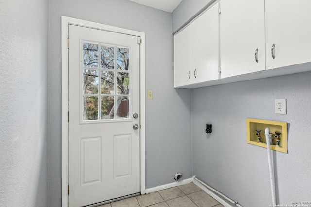 laundry area with hookup for an electric dryer, light tile patterned floors, cabinets, and washer hookup