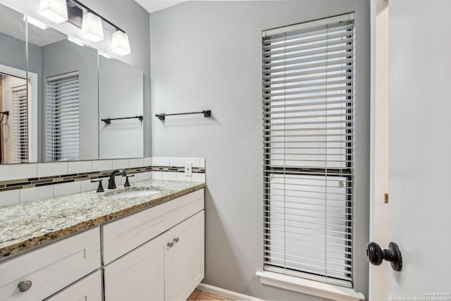 bathroom with backsplash and vanity