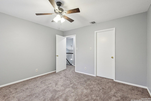 unfurnished bedroom featuring ceiling fan and light carpet