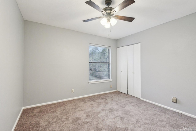 unfurnished bedroom with ceiling fan, a closet, and carpet floors