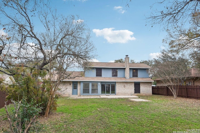 back of house with a yard