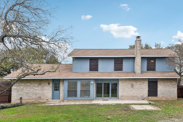 back of property featuring a lawn