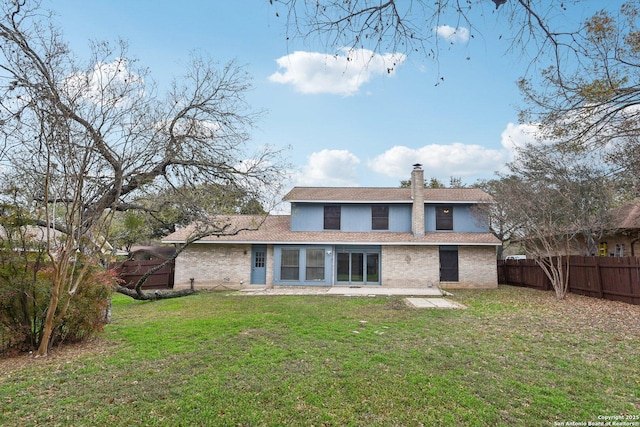 back of house with a yard