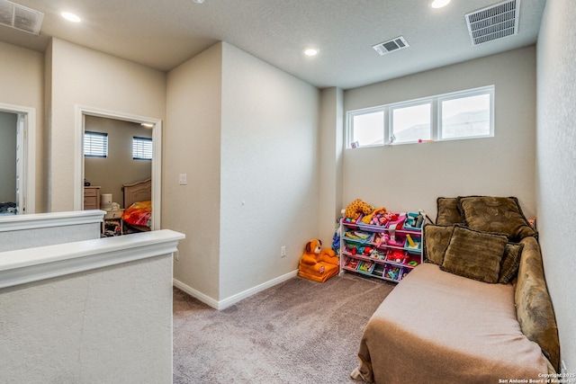 rec room with plenty of natural light and light carpet