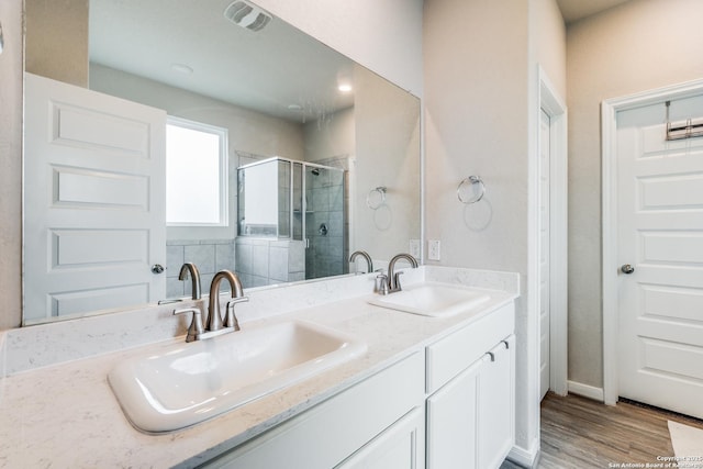 bathroom with vanity, hardwood / wood-style flooring, and walk in shower