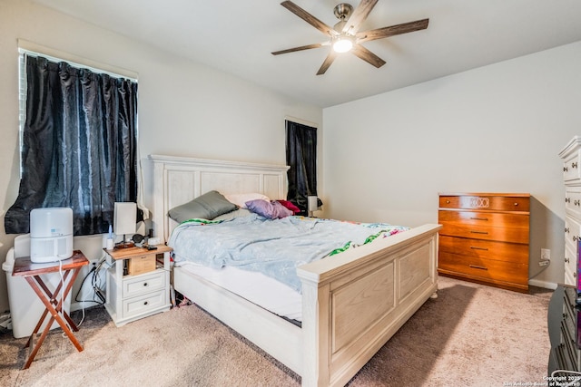 bedroom featuring ceiling fan and light carpet