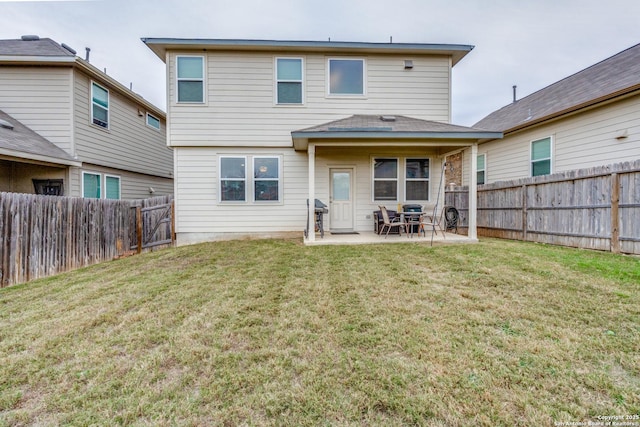 rear view of property with a patio area and a lawn