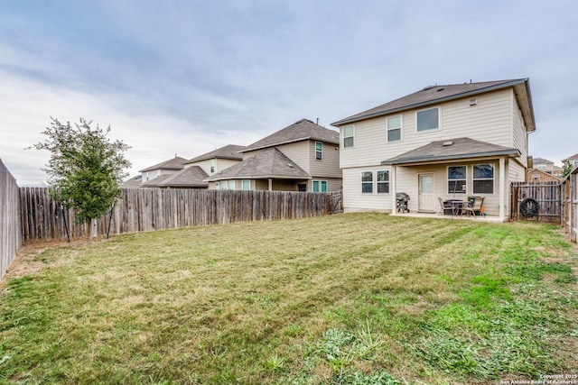 back of property featuring a patio and a lawn