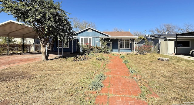 view of front of house with a front lawn and a carport