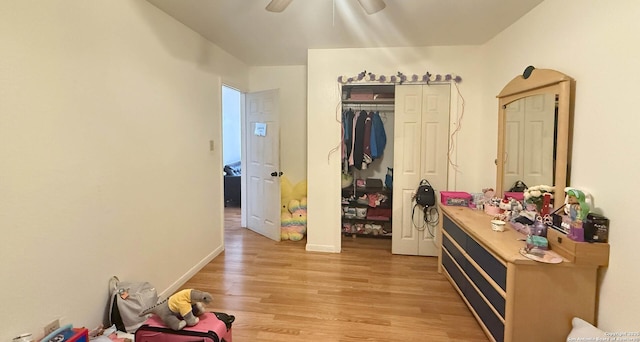 interior space with ceiling fan, a closet, and light hardwood / wood-style floors