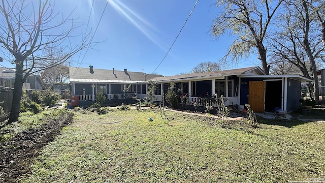 rear view of house with a lawn