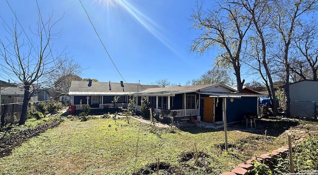 rear view of house with a yard