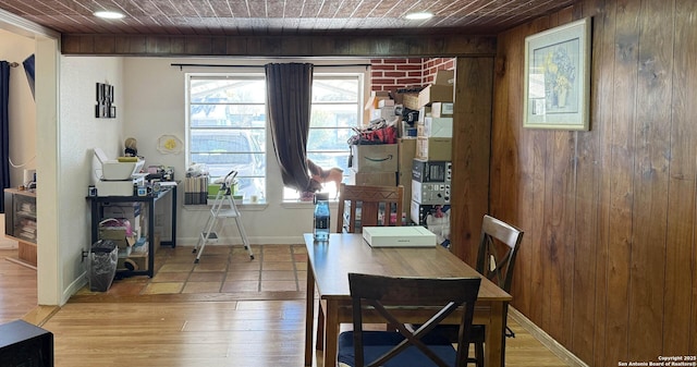 dining room with wooden ceiling, light hardwood / wood-style flooring, and a healthy amount of sunlight