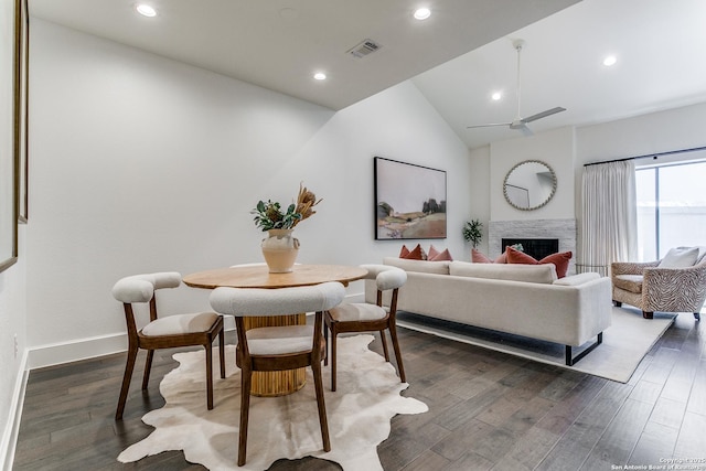 living room featuring dark hardwood / wood-style floors, ceiling fan, and lofted ceiling