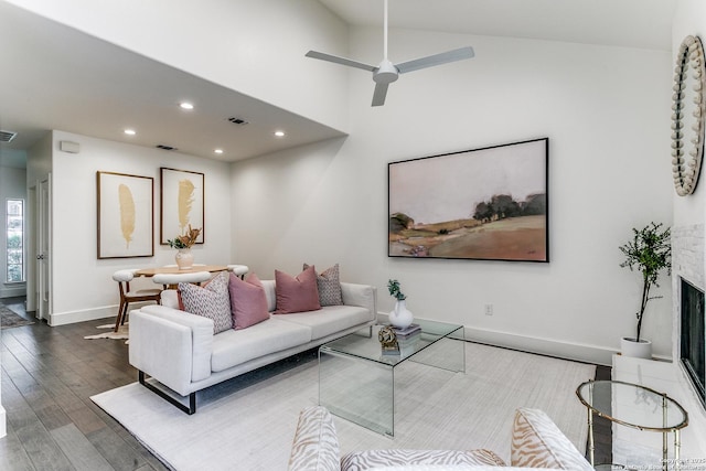 living room featuring hardwood / wood-style floors, ceiling fan, and lofted ceiling