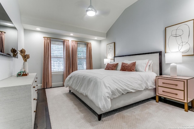 bedroom featuring light carpet and vaulted ceiling