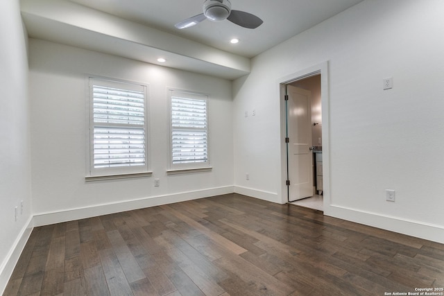 empty room with ceiling fan and dark wood-type flooring