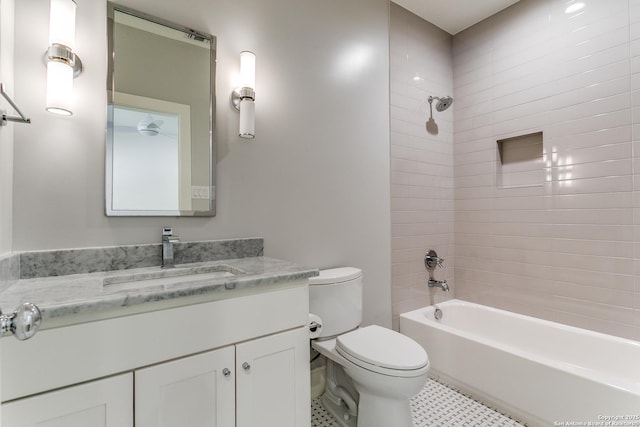 full bathroom featuring vanity, toilet, and tiled shower / bath