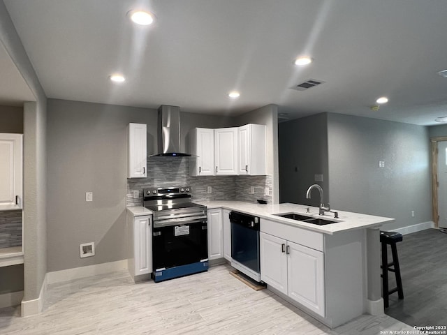 kitchen with kitchen peninsula, stainless steel range with electric stovetop, wall chimney range hood, dishwasher, and white cabinetry